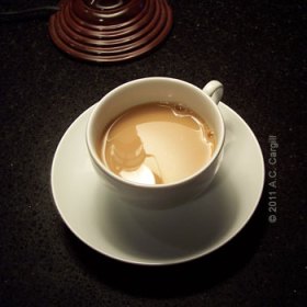 In the cup with milk and sweetener