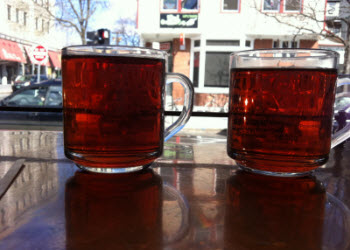 Two cups of Tealuxe tea watching the world go by (photo is mine)