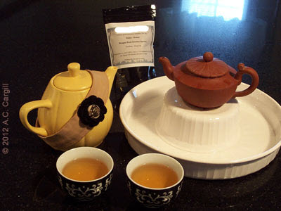 Little Yellow Teapot supervises while Yixing teapot ‘Simplicity’ steeps up a perfect Dragonwell. (Photo source: A.C. Cargill, all rights reserved)